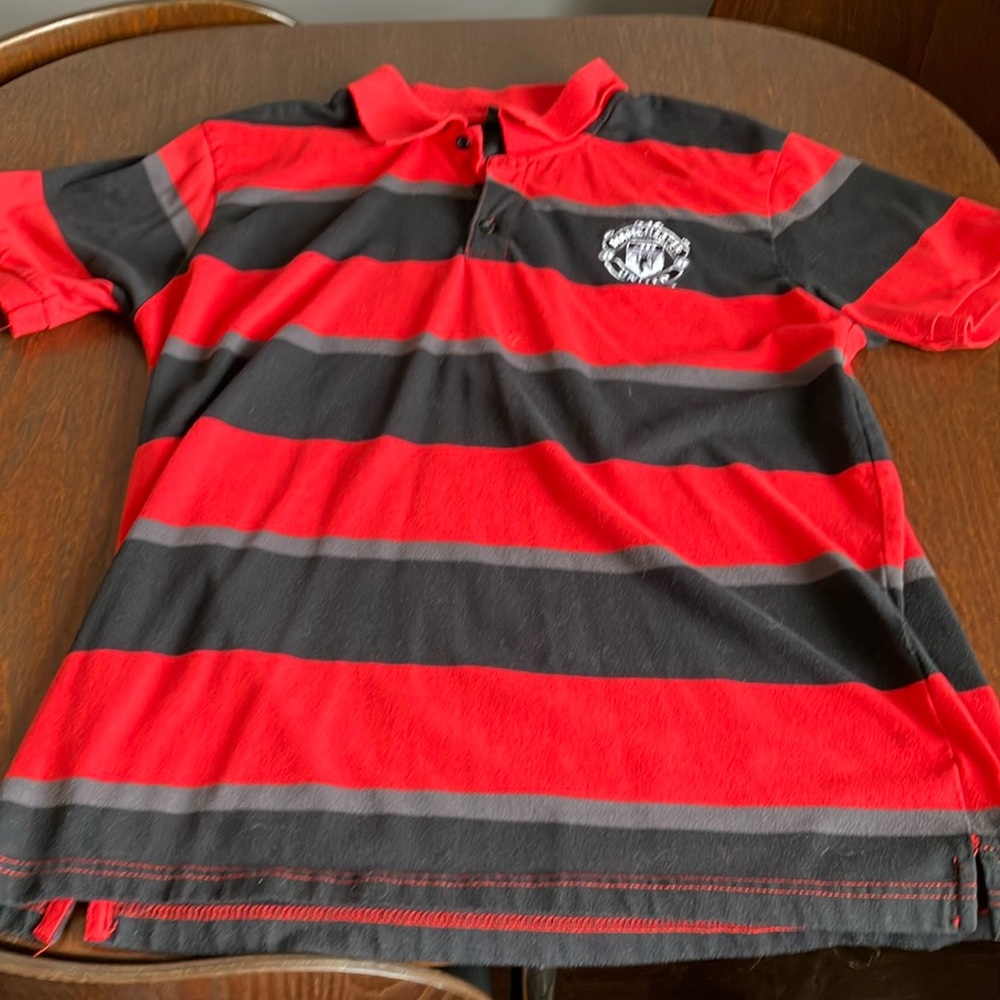 Manchester United polo shirt.